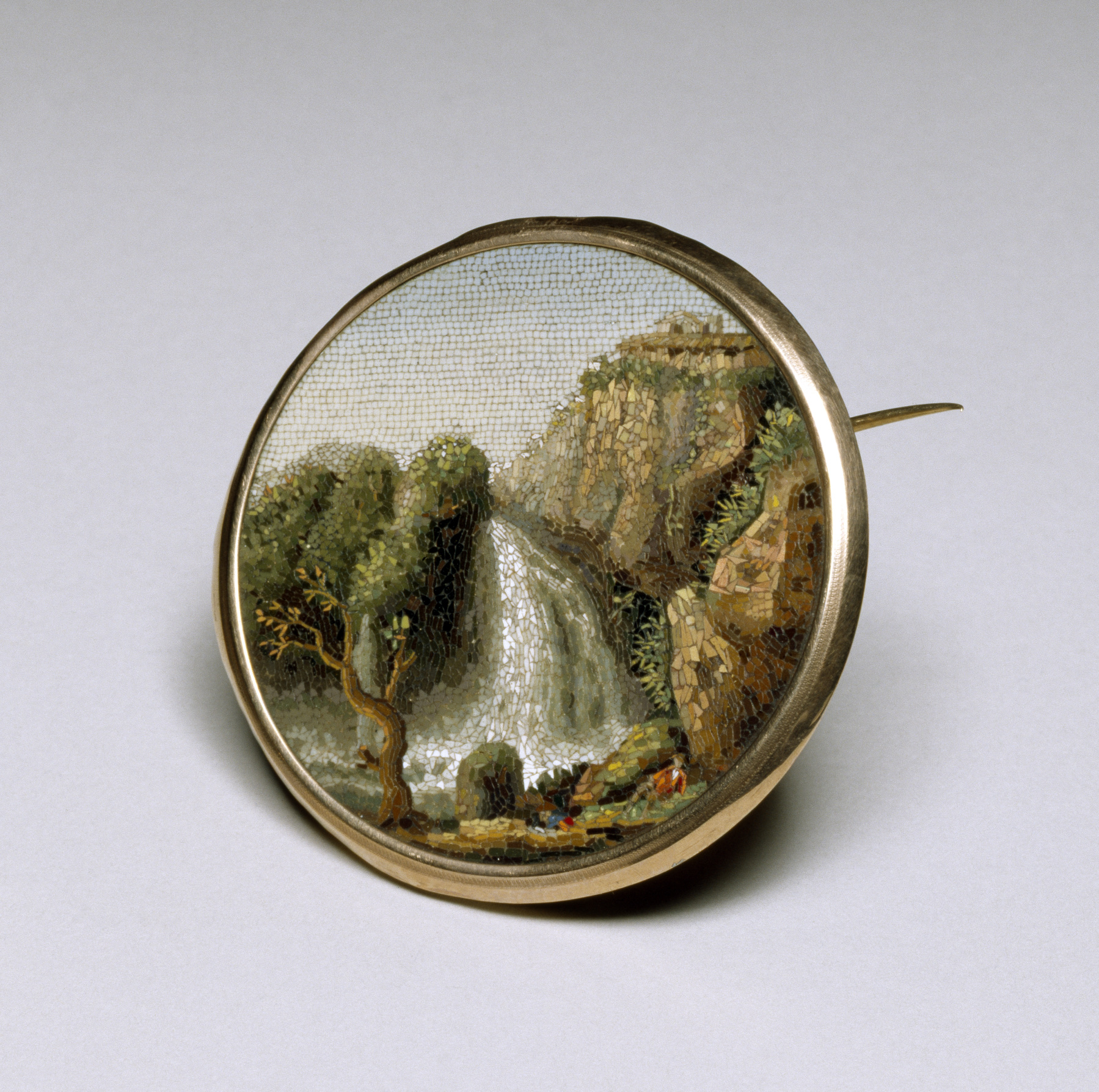 Italian micromosaic brooch with a river, waterfalls, trees and buildings in a gold setting